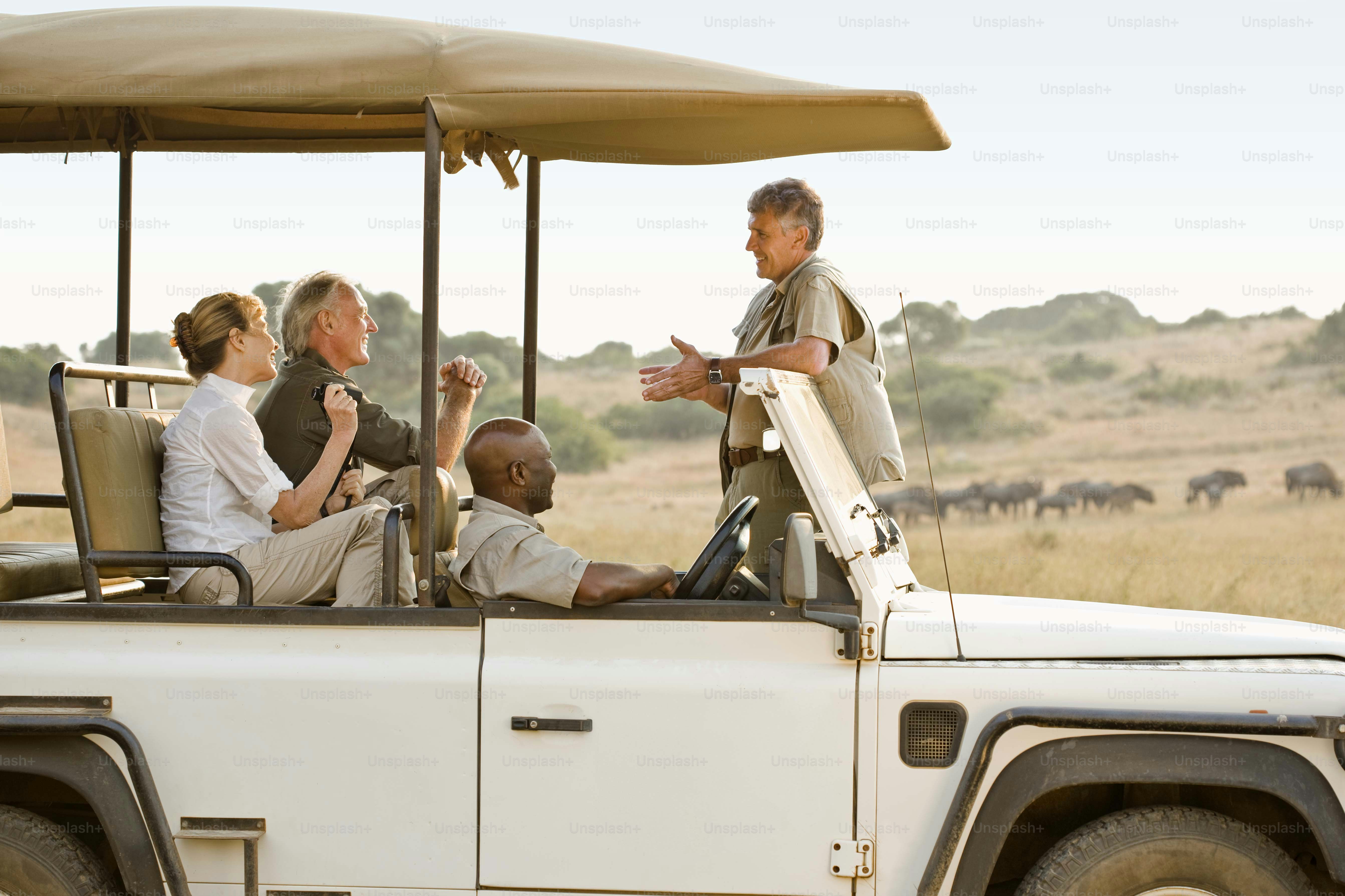 a group of people riding in the back of a white jeep